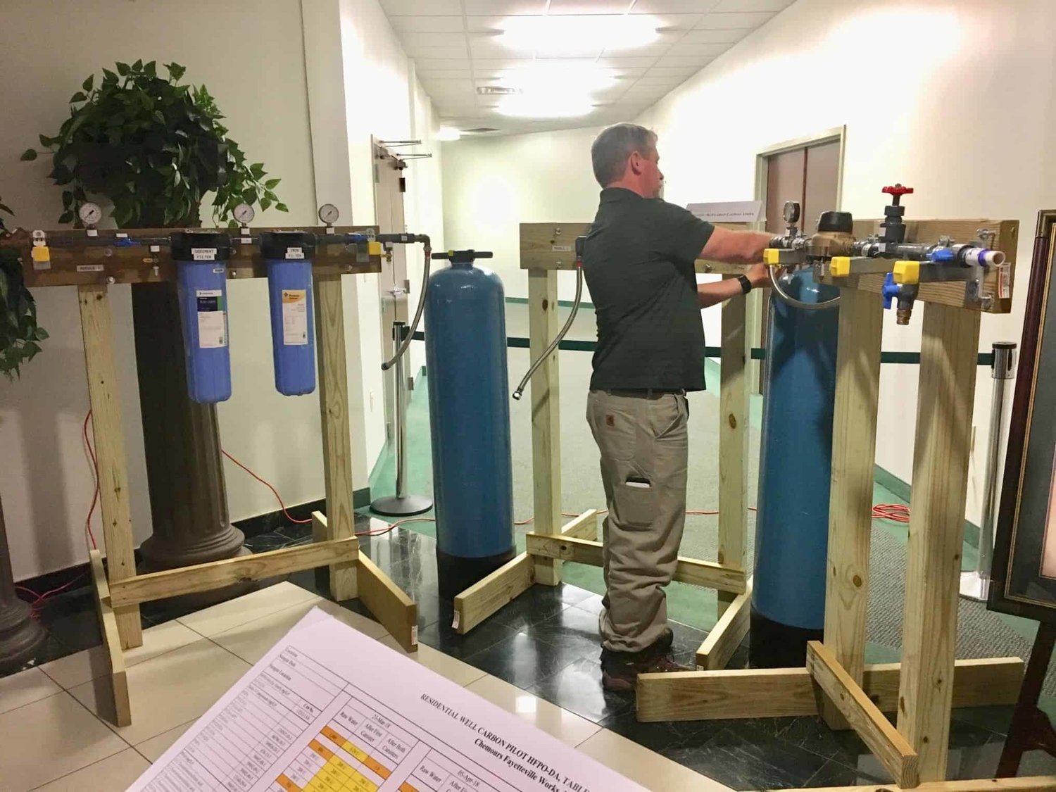 A Chemours technician arranges a mockup of a granular-activated carbon system that can be installed to filter water from local wells that have tested positive for GenX.