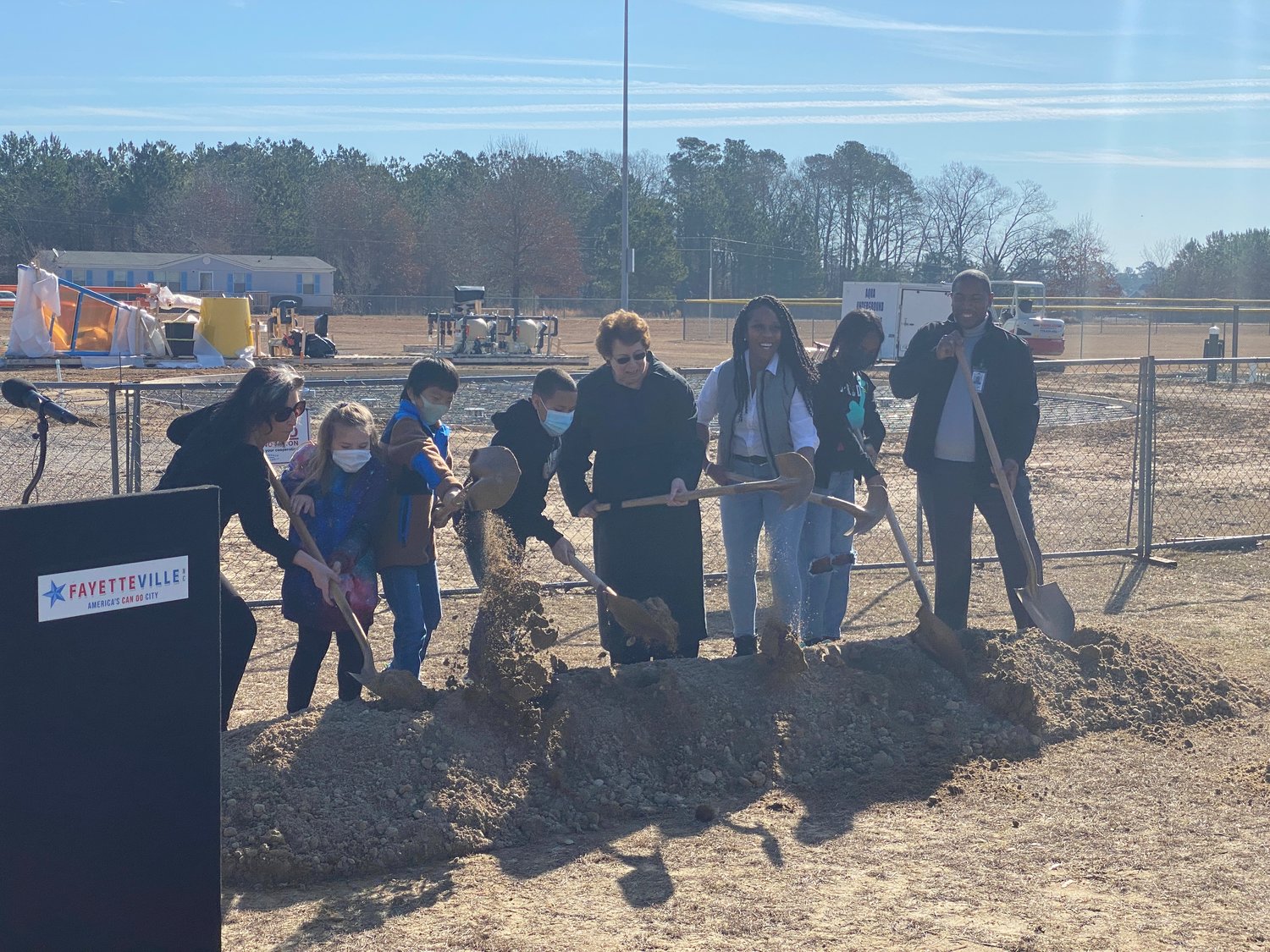 City officials, members of the Kiwanis Club of the Cape Fear and students from Lake Rim Elementary School take part in a groundbreaking ceremony Friday for a splash pad at Lake Rim Recreation Center.