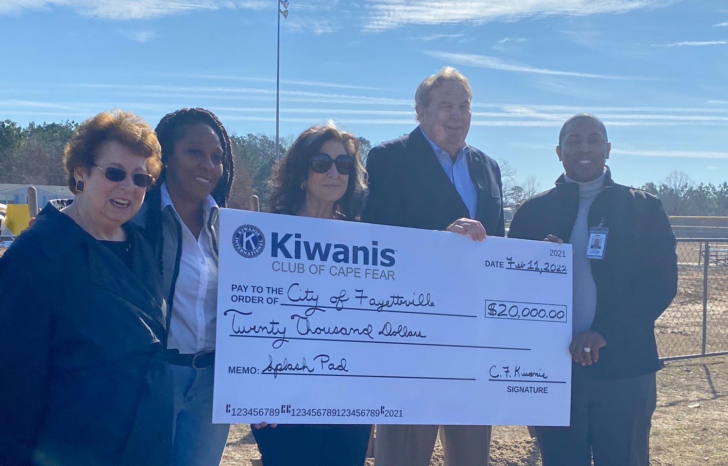 The Kiwanis Club of Cape Fear presents a $20,000 check to the city of Fayetteville for a splash pad at Lake Rim Recreation Center on Friday.