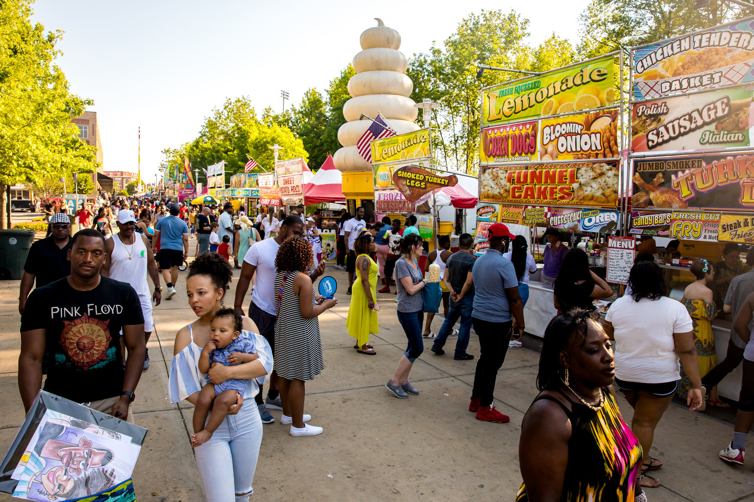 People gather at the food booths during the 2019 Fayetteville Dogwood Festival.