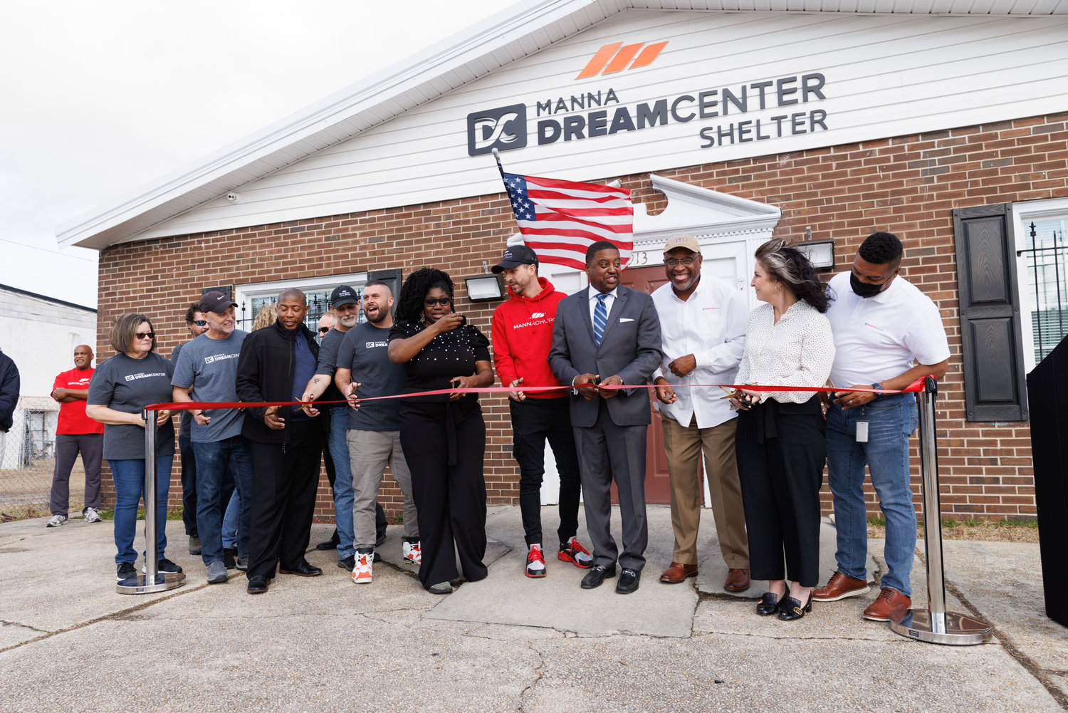 Members of the Fayetteville City Council, Manna Church and Dream Center staff cut a ribbon for the Manna Dream Center Shelter on Friday.