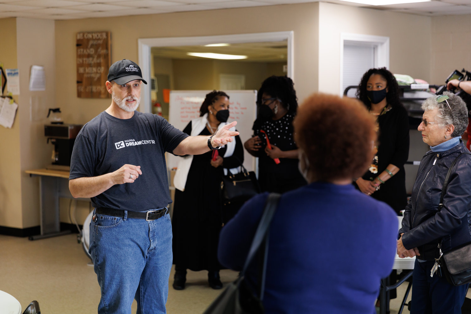 Ed Robillard, the director of the two Manna Dream Centers in Fayetteville, begins a tour of the Person Street shelter following the ribbon-cutting ceremony Friday.