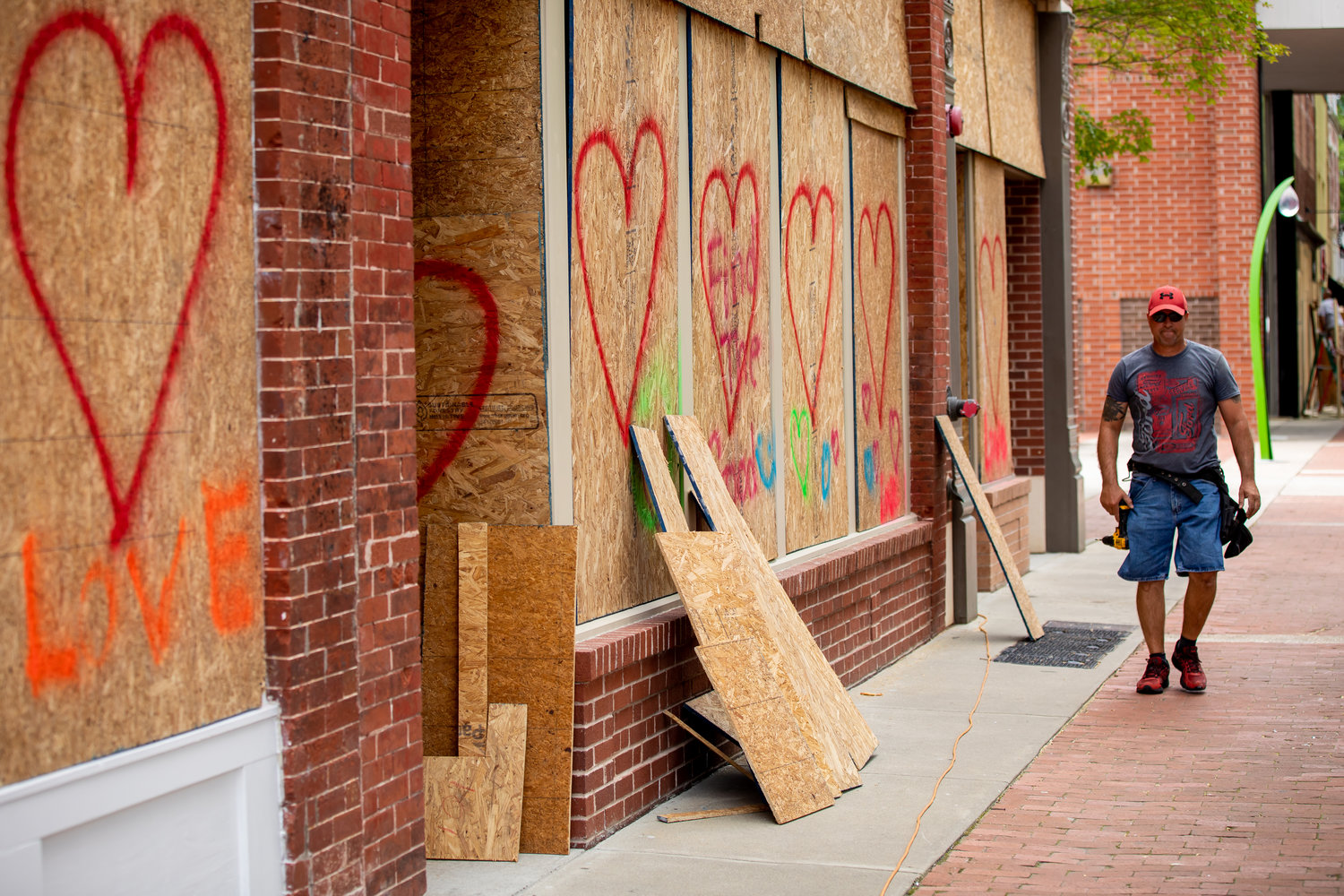 Business owners and volunteers on May 31, 2020, worked to clean up damage after downtown storefront windows were smashed the night before when protests turned violent.