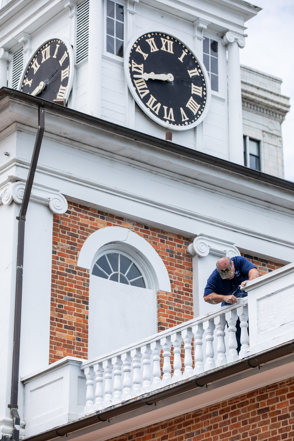 People work on May 31, 2020, to repair damage that was done to the Market House the night before when protests turned violent.