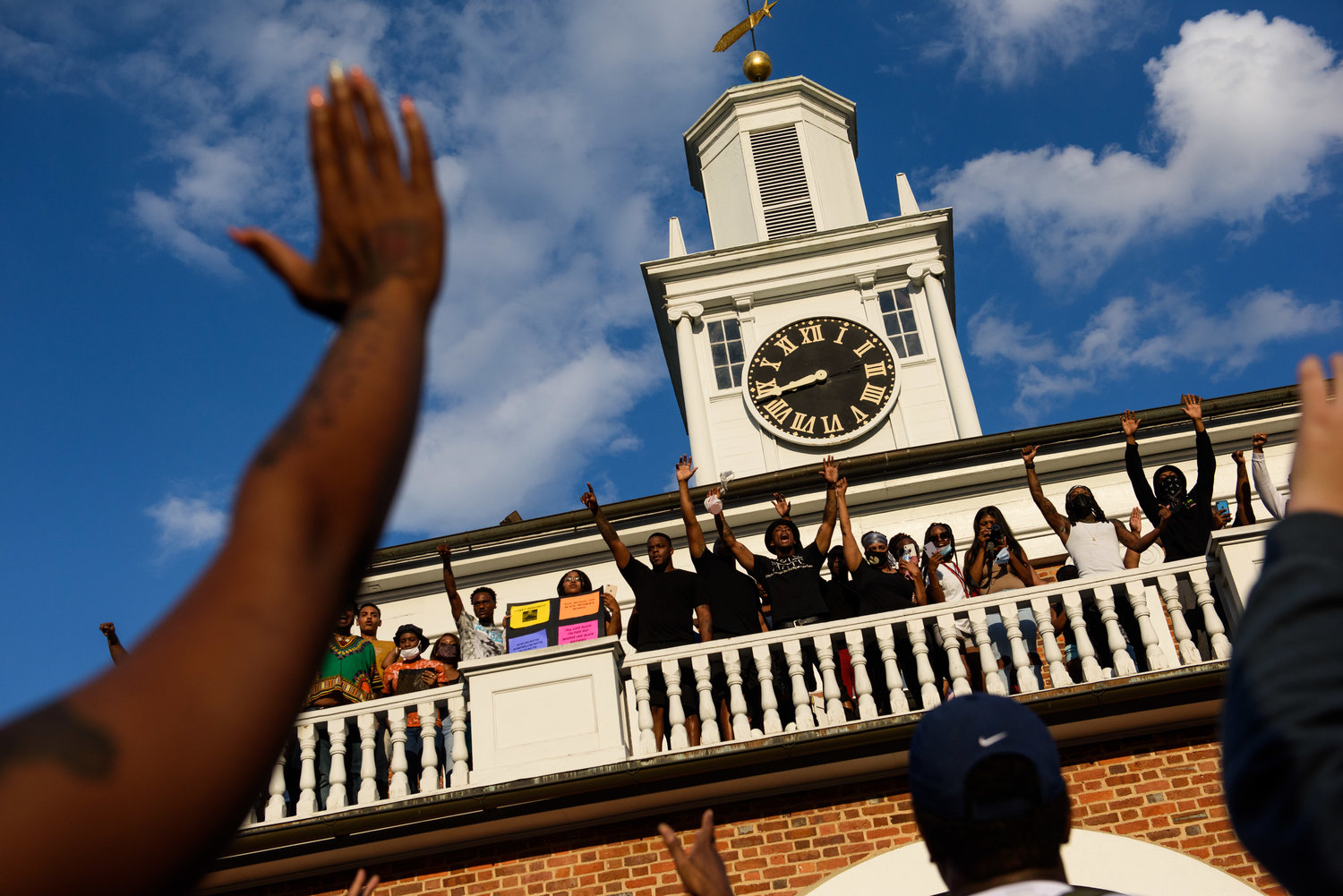 People gather on the balcony of the Market House during a protest on May 30, 2020. Damage that was done to the building has been repaired, and the city is preparing to remove the fencing that has surrounded the structure.