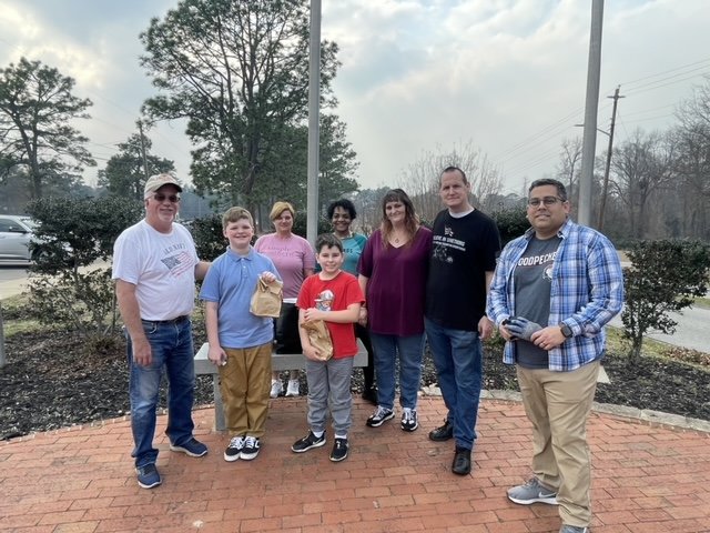 Spring Lake Alderman Marvin Lackman, Grady McLaughlin, 10; Melissa Pereira, Levi Palacios, 8; Alderwoman Adrian Thompson, TJ Smith and Trista Smith with Rustic Burger, and Alderman Raul Palacios gathered to clean up the Spring Lake Veterans Memorial Park at Main and Ruth streets on Saturday.