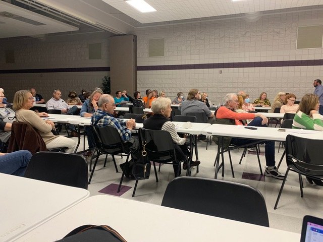 Residents listen to their lawyer Ben Kuhn during a meeting Tuesday at the Honeycutt Recreation Center to discuss their options concerning a proposed halfway house on Cain Road.