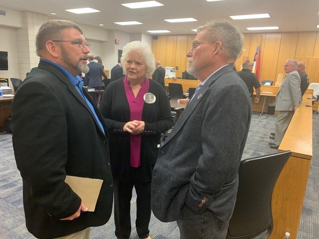 Dixie Lowry Davis talks with retired N.C. Highway patrolman Jake Katzenberger, left, and her brother-in-law Al Lowry during Monday’s hearing at the Judge E. Maurice Braswell-Cumberland County Courthouse.