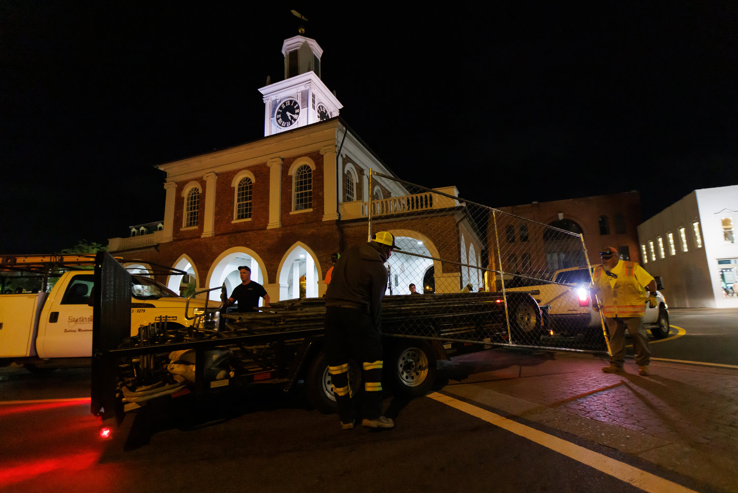 Workers with the Fayetteville-Cumberland Parks & Recreation remove fencing from around the Market House on Thursday.