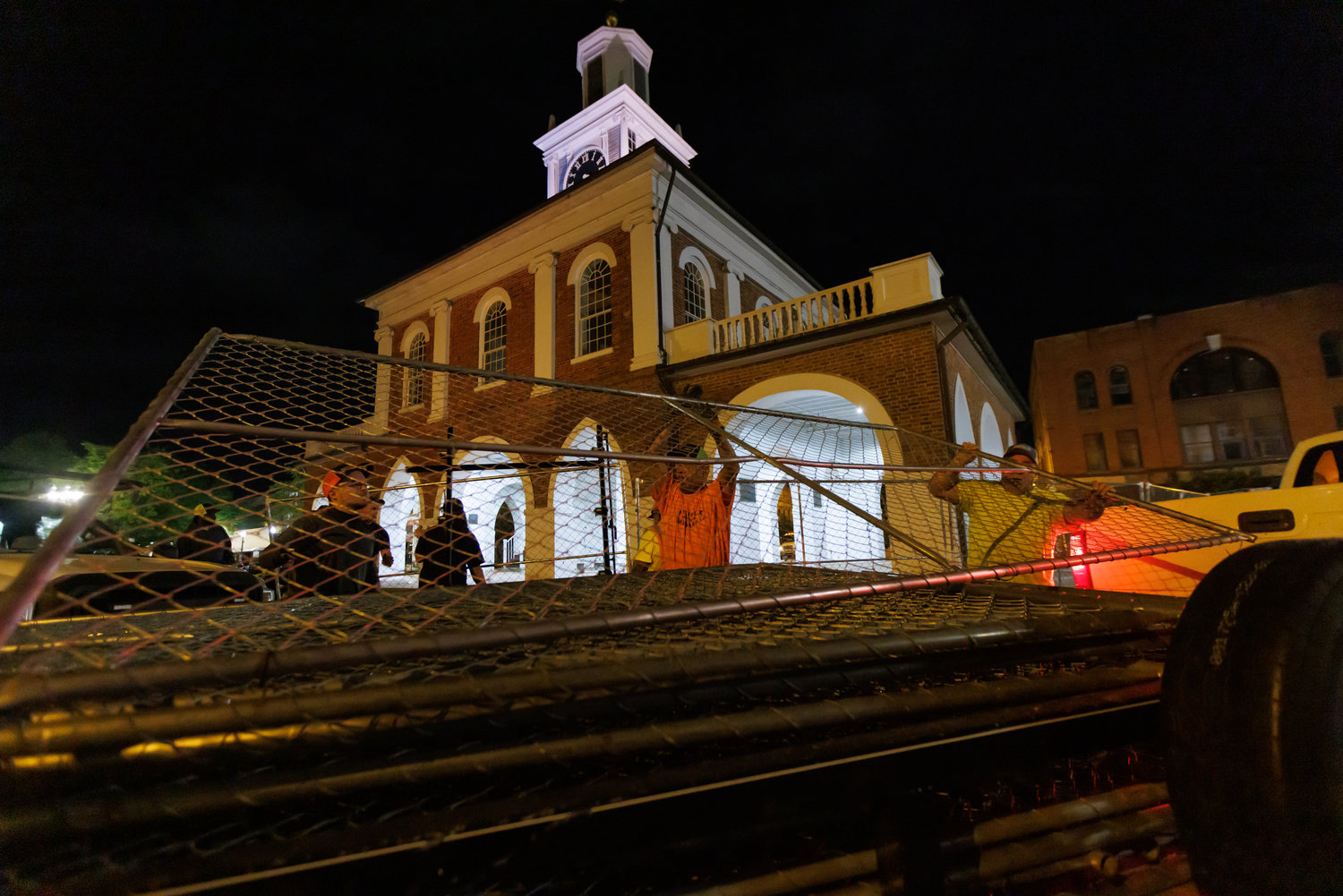 Workers from Fayetteville-Cumberland Parks & Recreation remove fencing from the Market House on Thursday.