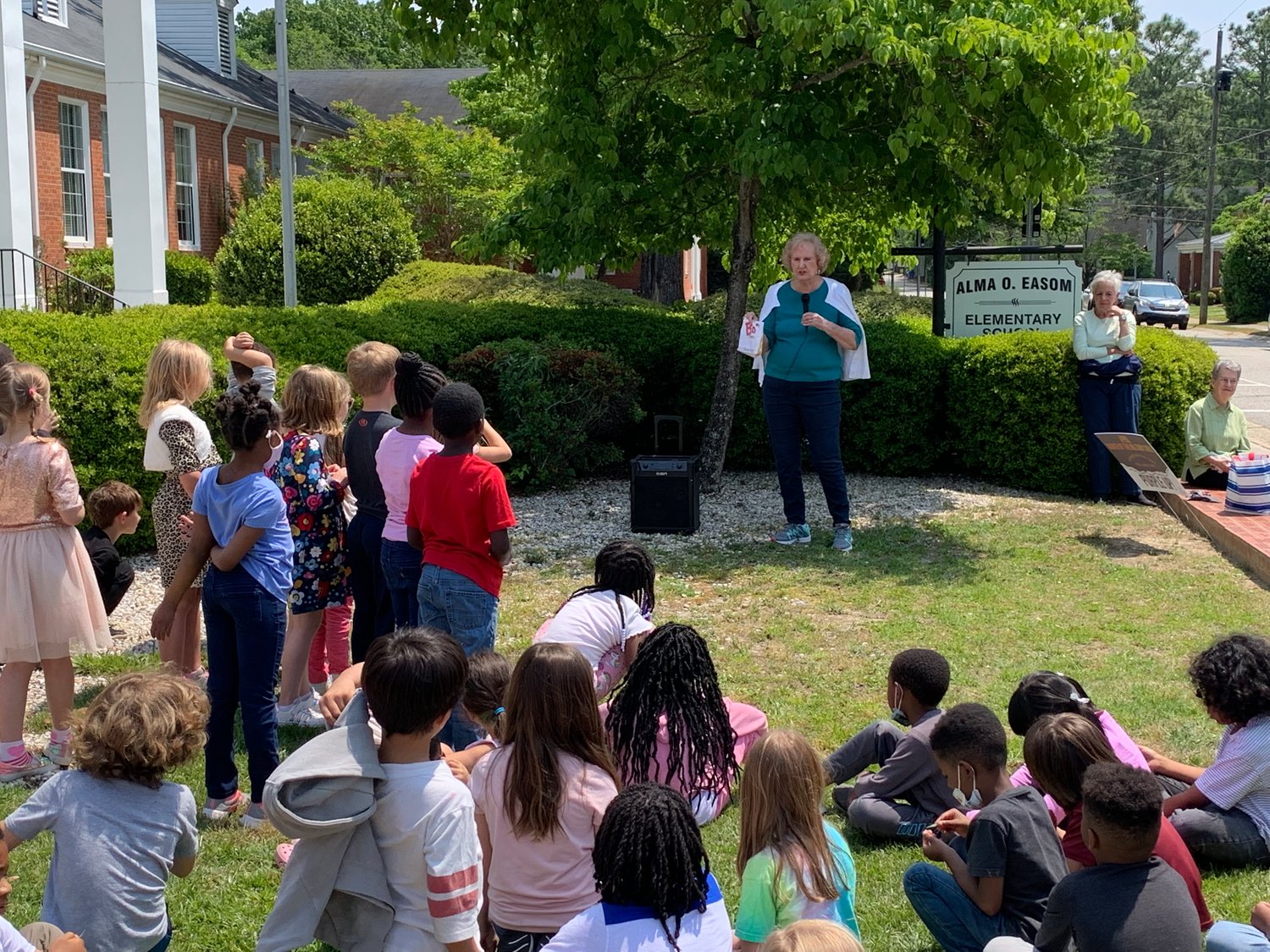 Sybil West, president of the Cross Creek Briarwood Garden Club, addresses first-graders at Alma Easom Elementary School.