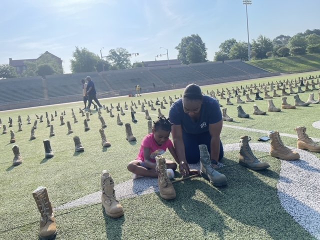 First Lt. Erika McCoy and her 5-year-old daughter McKenzie Huewitt help set up the display. 'Being out here and seeing all of the boots reminds us that our soldiers protect us and provide safety from outside forces,' she said.