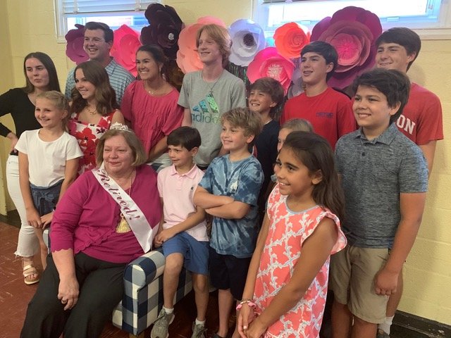 Students past and present gather around Debra Taft on Friday evening during a surprise reception in the school auditorium. Taft is retiring Wednesday after 30 years at Alma Easom Elementary School and 43 years with Cumberland County Schools.