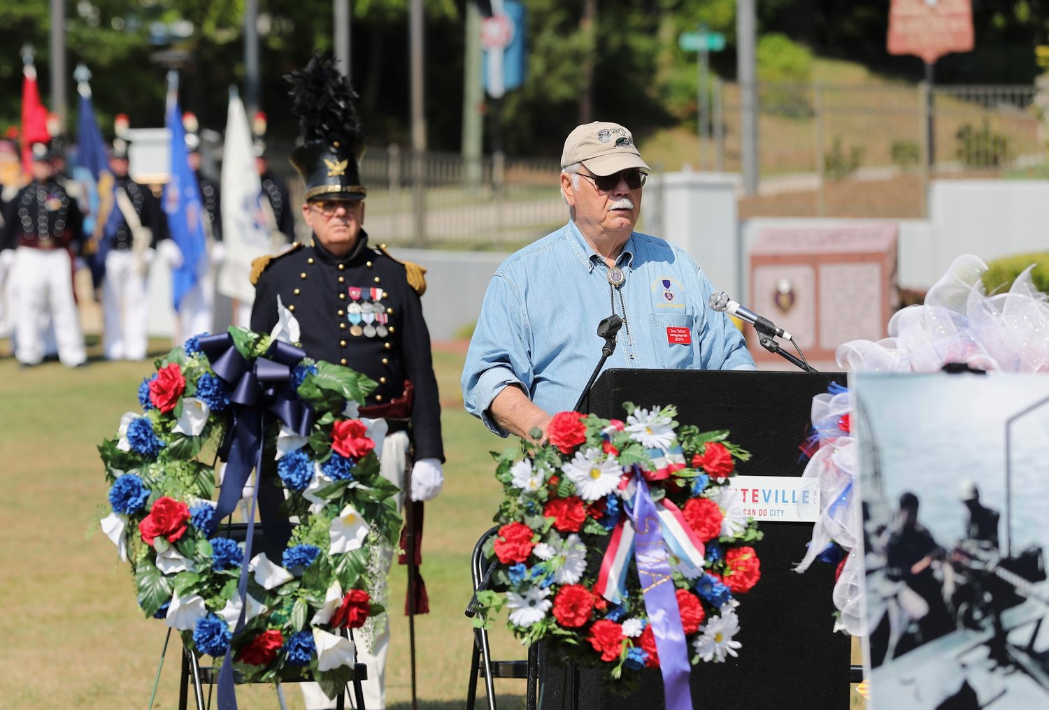 Don Talbot, chairman of the Freedom Memorial Park steering committee, prepares for the colors to post during the Memorial Day ceremony at Freedom Memorial Park on Monday.