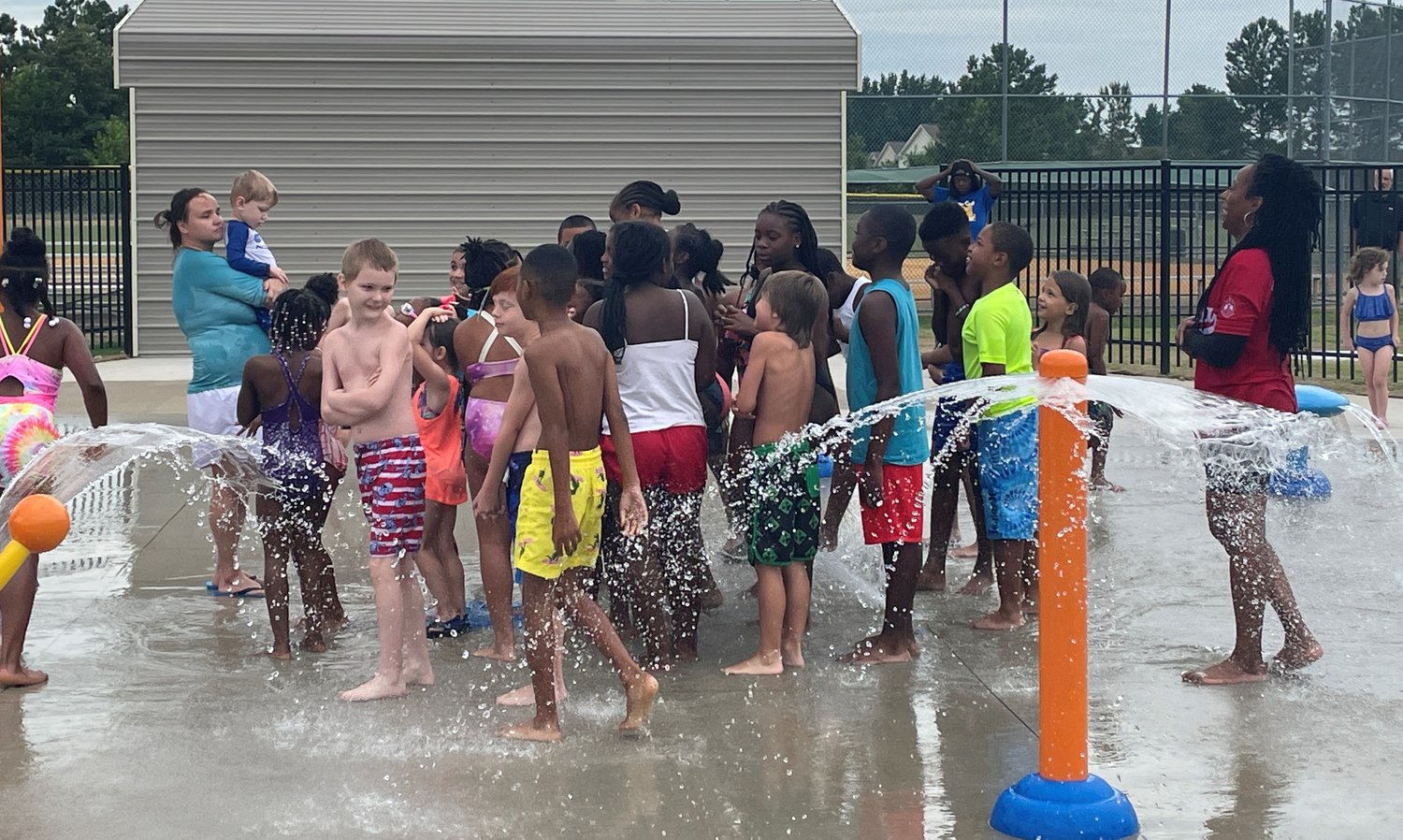 Children play in the splash pad at Lake Rim Recreation Center.