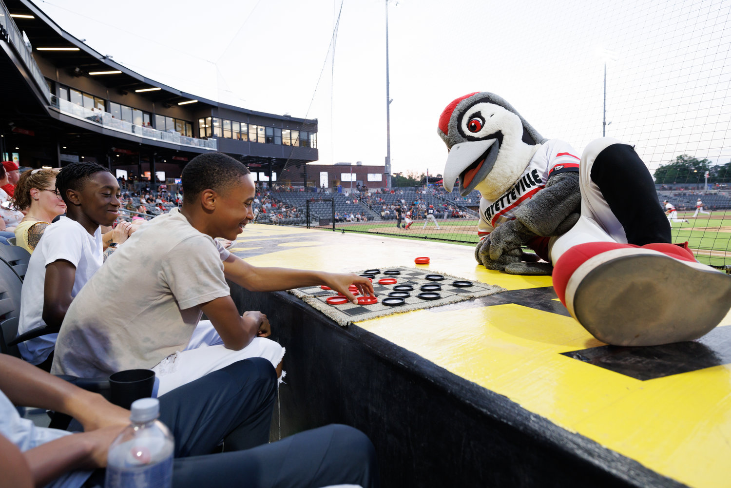 CHECK IT OUT: For a seventh inning stretch at Segra Stadium, how about a game of checkers? Woodpeckers mascot Bunker challenges Christopher Wooten during a game break on June 1 as Jaiden Dingle looks on.