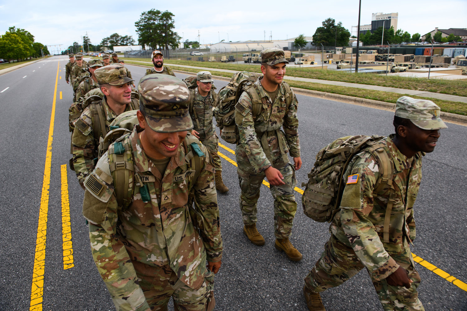 CALL OF DUTY: All American pride is on display as Army soldiers carry their rucksacks during early-morning physical training on Long Street on Fort Bragg. The 53,000-plus troops and their families who call the post home boost Fayetteville’s cultural diversity and its reputation worldwide.