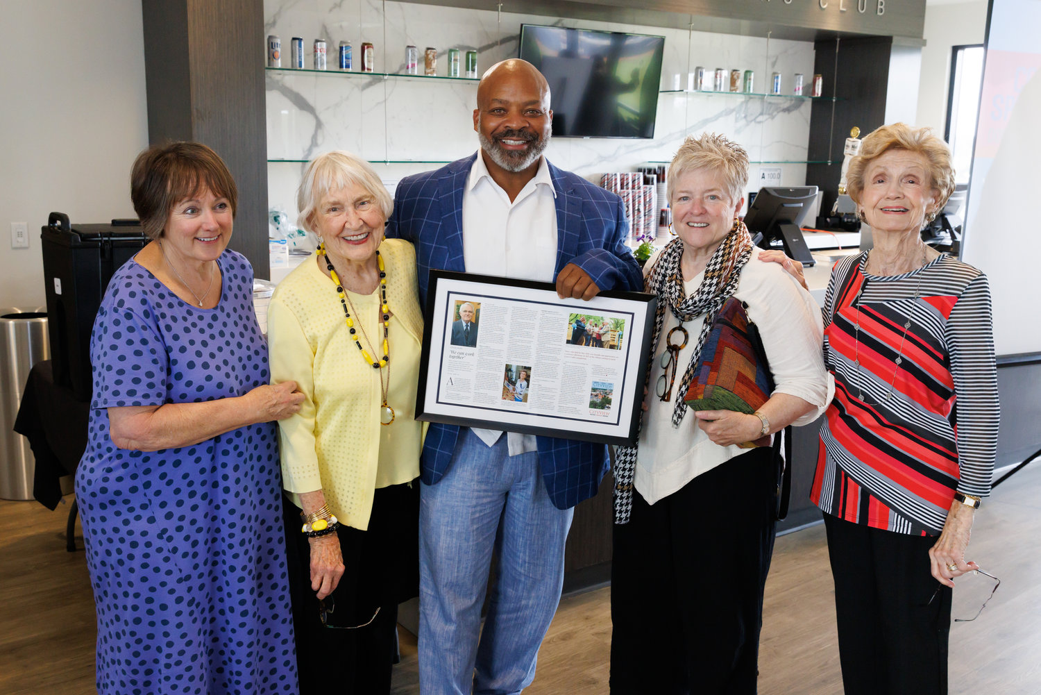 Daughter Sally Shaw Schmitz, sister Gillie Revelle, Cross Creek Linear Park landscape engineer Anthony Ramsey, daughter Faison Shaw Covington and widow Claire Shaw pose with the Harry Shaw Downtown Visionary award.