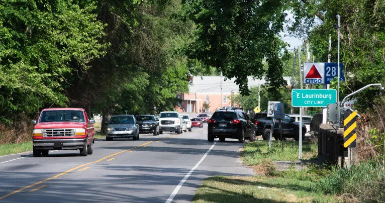 Cars line up on for gas in May 2021 on Andrew Jackson Highway at the town limit of East Laurinburg. The town was scheduled to become an unincorporated community within Scotland County on July 1.