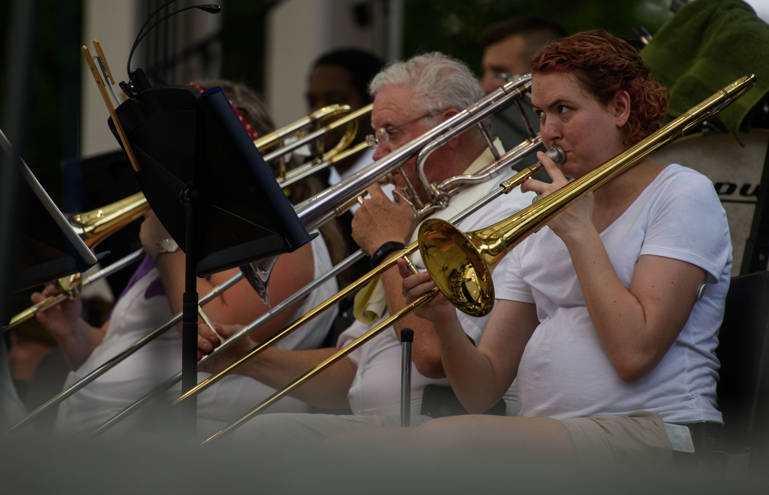 A trombone player watches the conductor during a performance with the Fayetteville Symphony Orchestra as part of the Independence Day celebration at Festival Park on Monday.