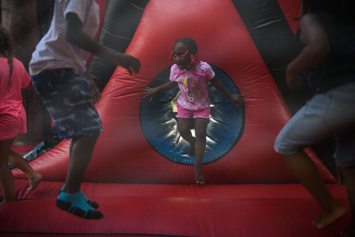 Kids play in a bounce house during the Independence Day celebration in Festival Park on Monday.