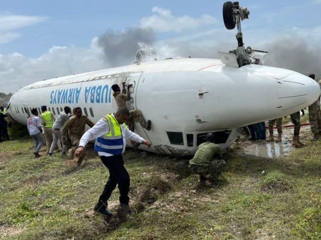 Somalia Danab brigade commandos and other first responders rush to evacuate passengers from a Jubba Airlines aircraft that crash-landed Monday at the Mogadishu International Airport. Three Fort Bragg soldiers with the Army's 2nd Security Force Assistance Brigade helped first responders care for injured passengers, the Army said.