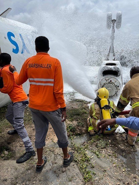 Somali first responders extinguish fire on a Jubba Airlines aircraft Monday at the Mogadishu International Airport. Three U.S. Army 2nd Security Force Assistance Brigade 
soldiers out of Fort Bragg helped first responders care for injured passengers, the Army said.