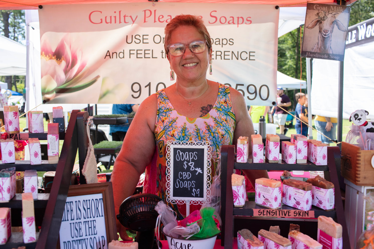 Norma Segui of Guilty Pleasure Soaps poses in front of her plethora of different scented soaps.