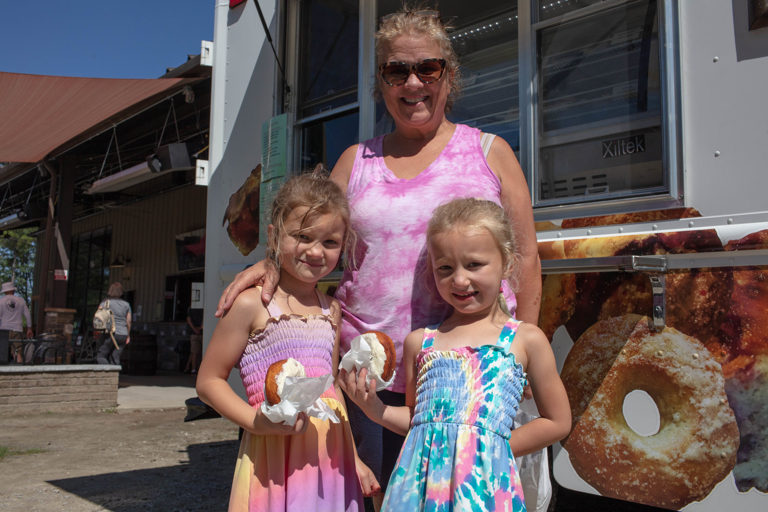 Olivia and Mckenzie Regan stopped by the dessert truck Dolores' Crumble Crust Pies for some donuts with their grandmother Liz Crosland.
