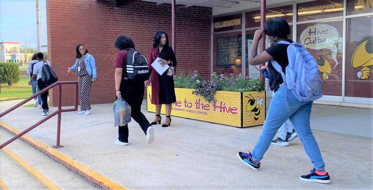 Students arrive for the first day of classes at Anne Chesnutt Middle School on Monday.