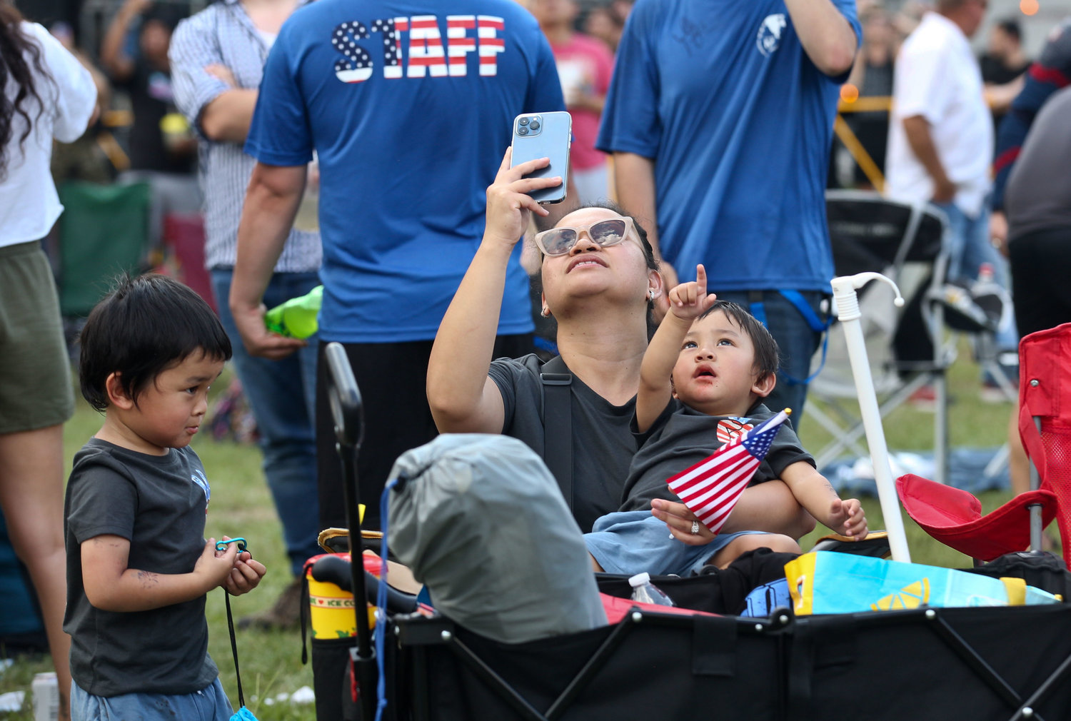People watch the Golden Knights parachute team.