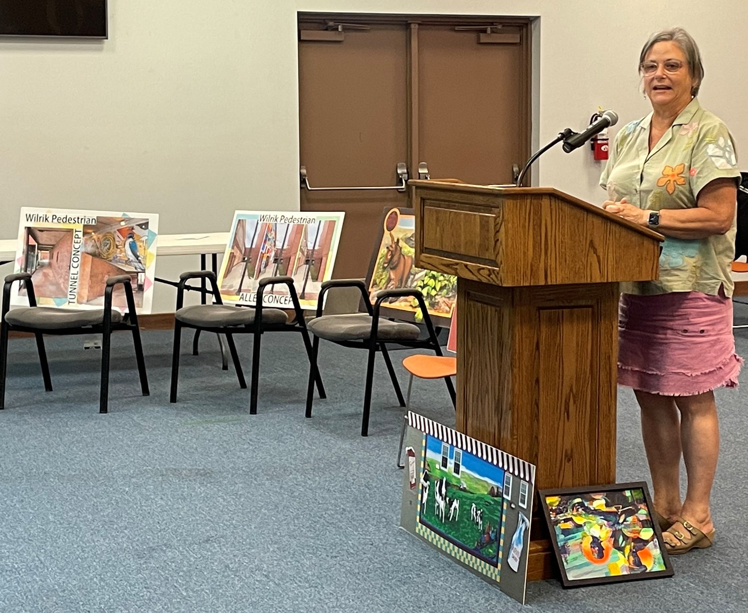 Liz Whitmore, the historic preservation planner for the city of Sanford, talks with the Spring Lake Board of Aldermen on Monday night about how Sanford has been able to bring public art, including murals, to that community.