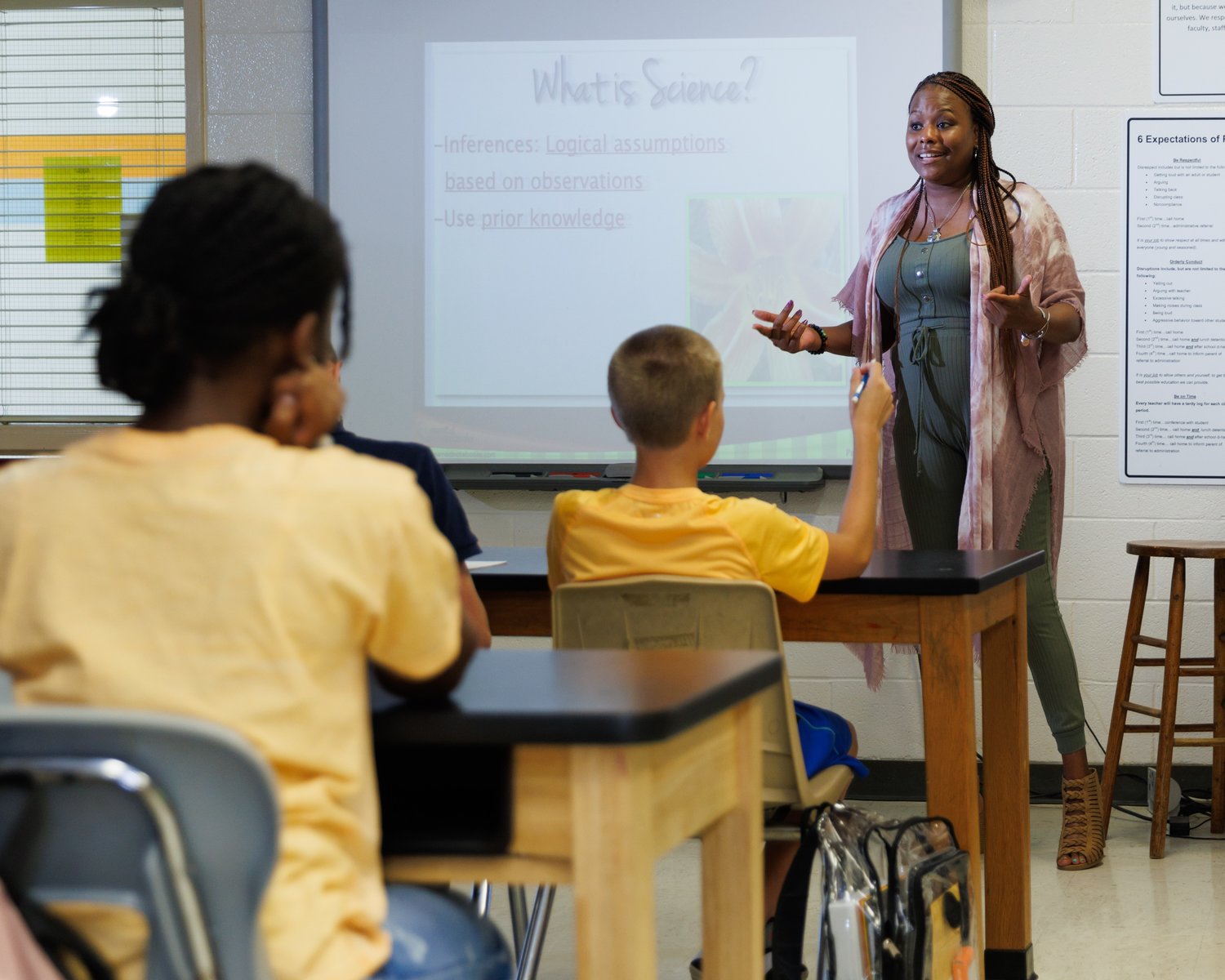 Erica Smalls, a sixth-grade science teacher, discusses the day’s lesson with her students at Reid Ross Classical School on July 25.