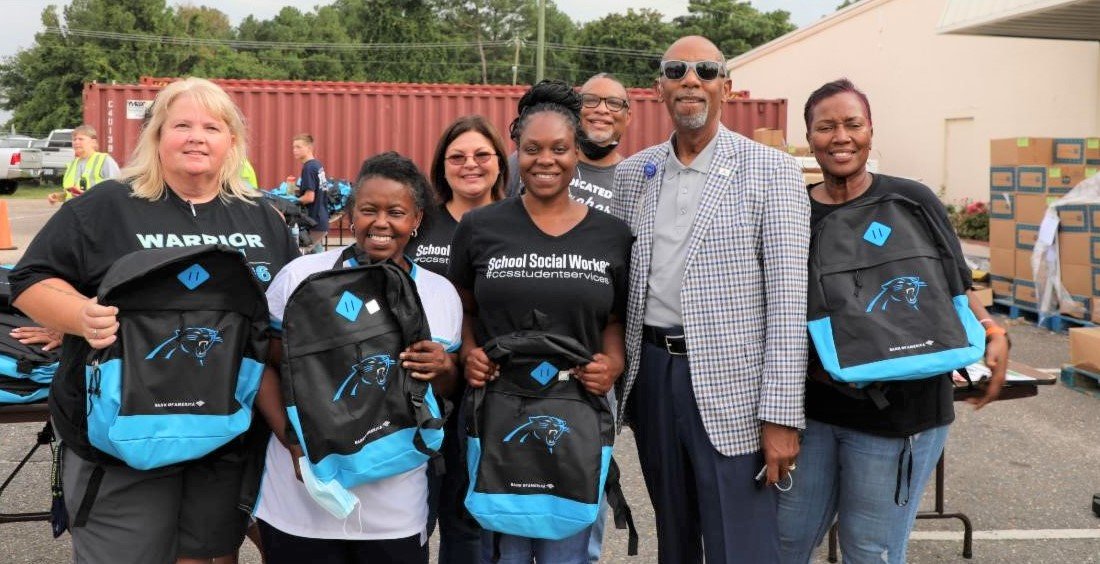 Superintendent Marvin Connelly Jr. and central services employees show some of the backpacks during a school supply giveaway at Balm in Gilead on Doc Bennett Road on Monday.