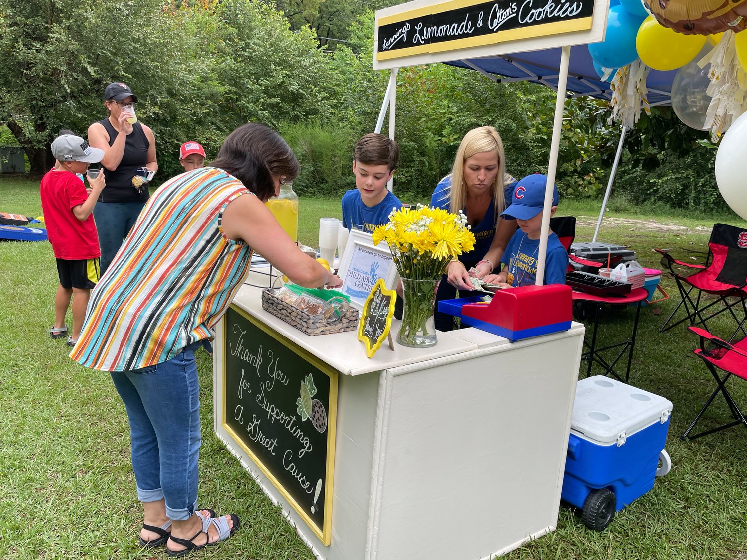 Customers visit Lanning's Lemonade & Colton's Cookies booth on Aug. 20. The fundraiser, in its fourth year, benefitted the Child Advocacy Center. It was the second year brothers Lanning Kistler and Colton Walters gave proceeds from the fundraiser to the organization.