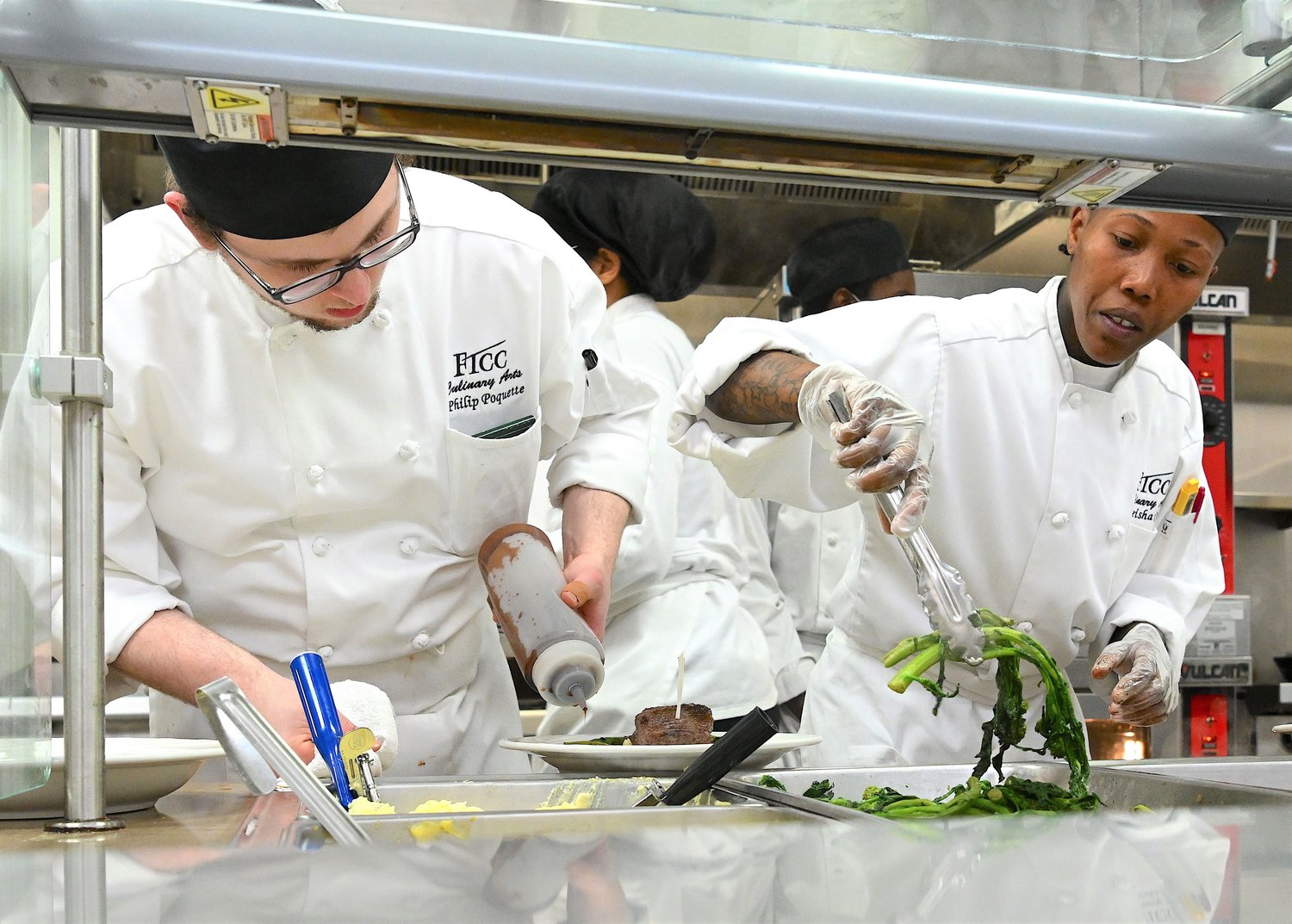 Culinary arts students at Fayetteville Technical Community College prepare a meal at the college to gain real-world experience in food preparation and presentation.