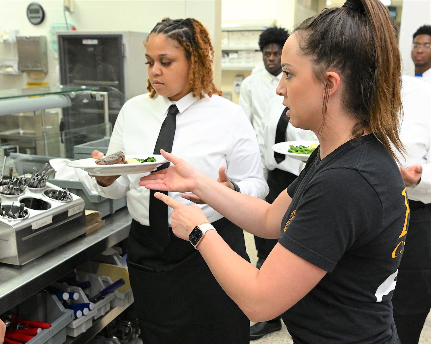 A culinary arts student gets instruction at FTCC.