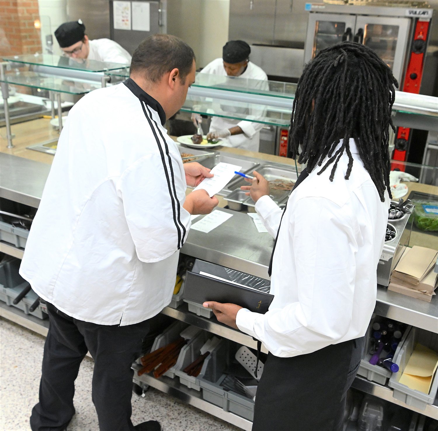 A student checks a meal order during the dinner prepared by FTCC students.