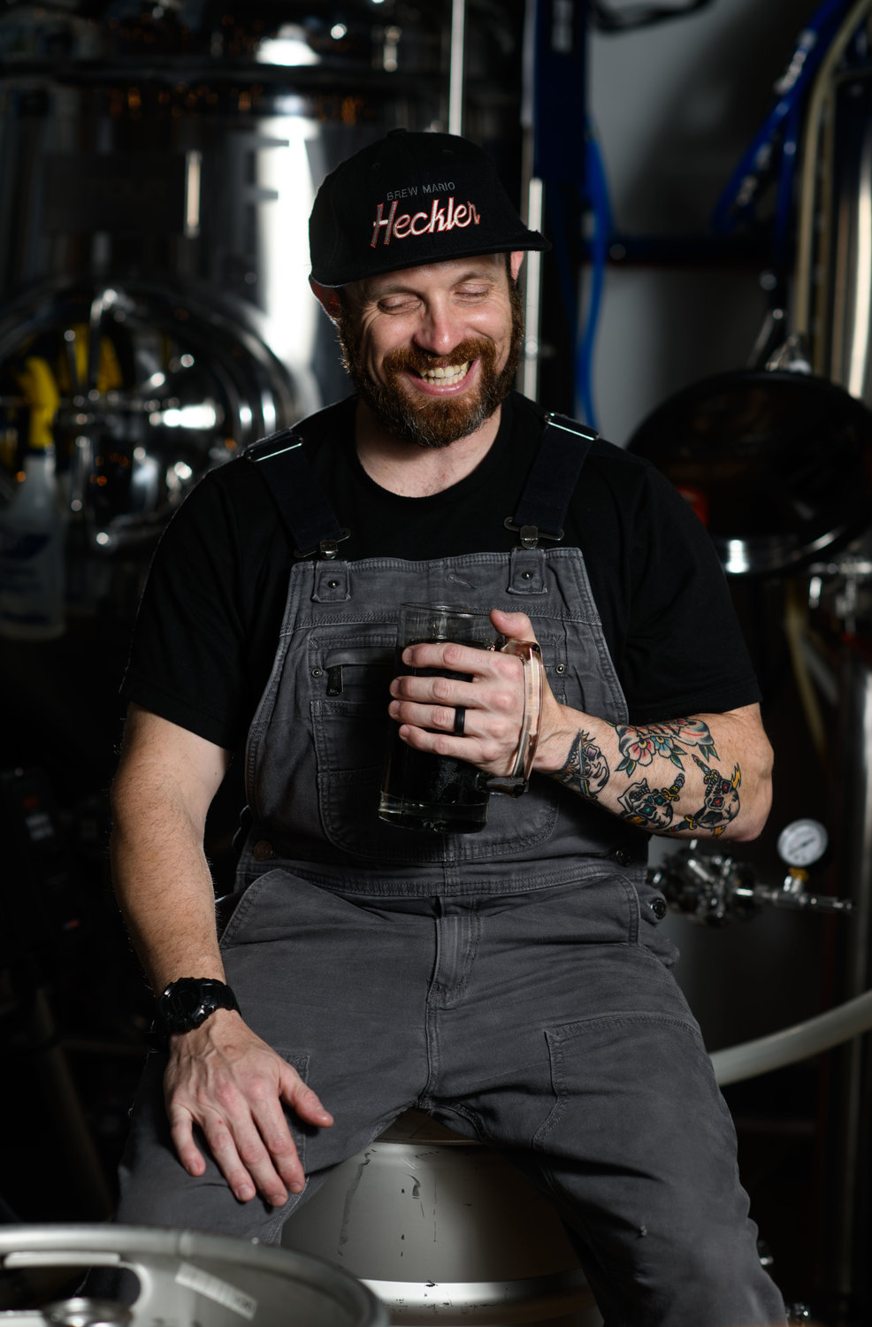 Assistant Brewer, Ken Bowman, poses for a portrait with his personal brew called Pirate Hooker, a milk stout he home brewed and then took to Heckler.