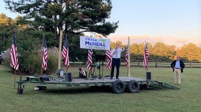 Gov. Roy Cooper campaigns Monday at a Democratic District 21 state Senate fundraiser for Frank McNeill, right, in Moore County.