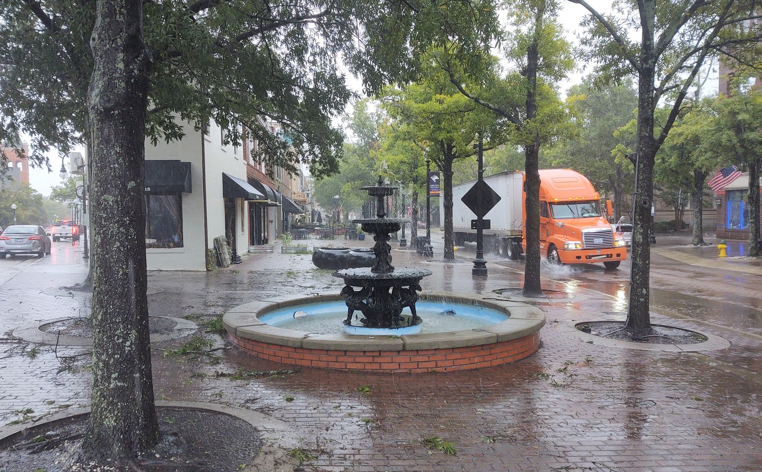 A tractor-trailer splashes water on the curb on Hay Street in downtown Fayetteville just before 5 p.m. Friday as the remnants of Hurricane Ian passed through the region.