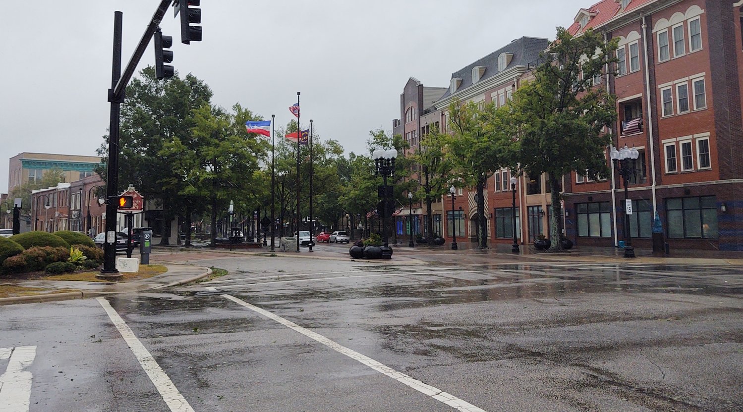 Flags flutter in gusty wind and stinging rain at Hay Street and Ray Avenue in downtown Fayetteville just before 5 p.m. Friday as the remnants of Hurricane Ian passed through the region.