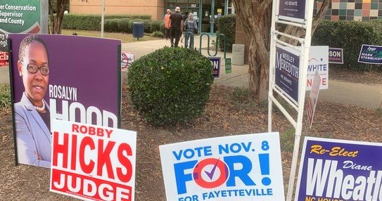 Campaign signs greet early voters at the Kiwanis Recreation Center.