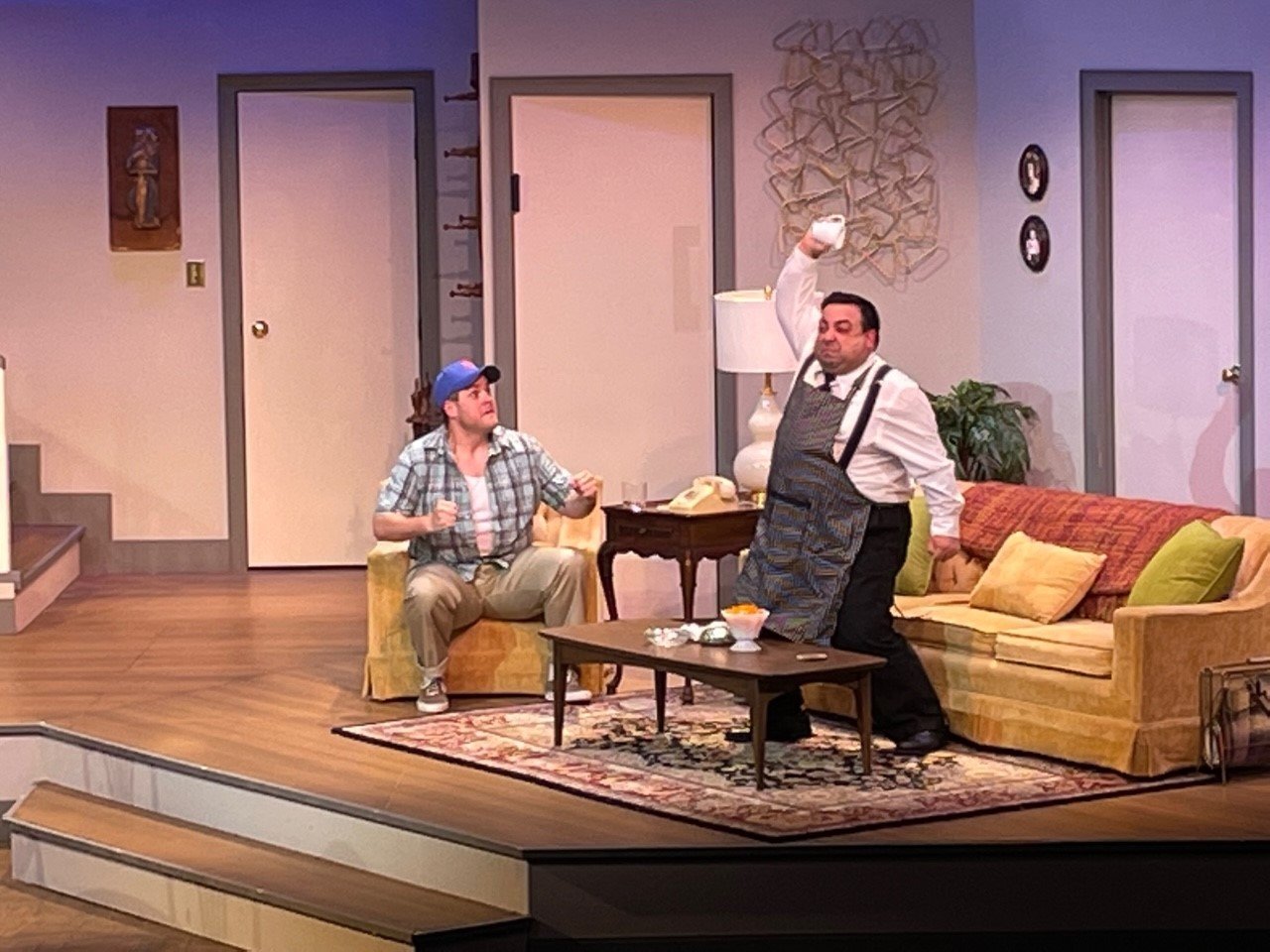 Oscar, left, played by Jonathan Judge-Russo, encourages Felix, played by Marc de la Concha, to let out his emotions and throw the cup.'The Odd Couple' continues at Cape Fear Regional Theatre through Nov. 13.
