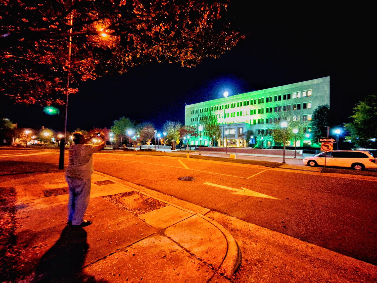 Glenn Adams, chairman of the Cumberland County Board of Commissioners, takes a photo of the Judge E. Maurice Braswell Cumberland County Courthouse on Monday night. Cumberland County is participating in Operation Green Light, a national collaborative effort to show appreciation to America’s veterans.