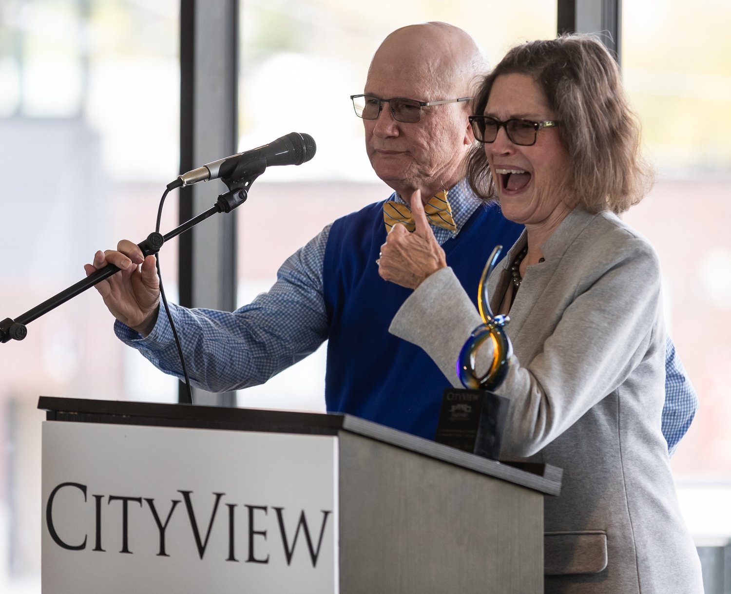 Lucy Jones gestures to someone in the audience as she and her husband, Wes, accept their CityView Community Impact Awards on Wednesday.