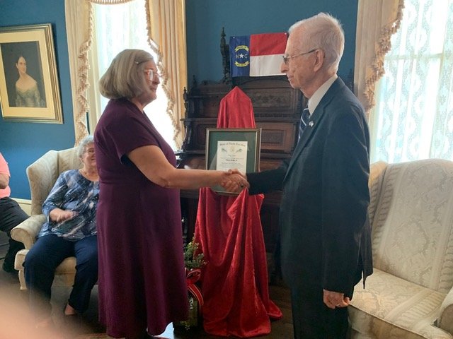 Lynda Deaton presents the Order of the Long Leaf Pine to Weeks Parker Jr.