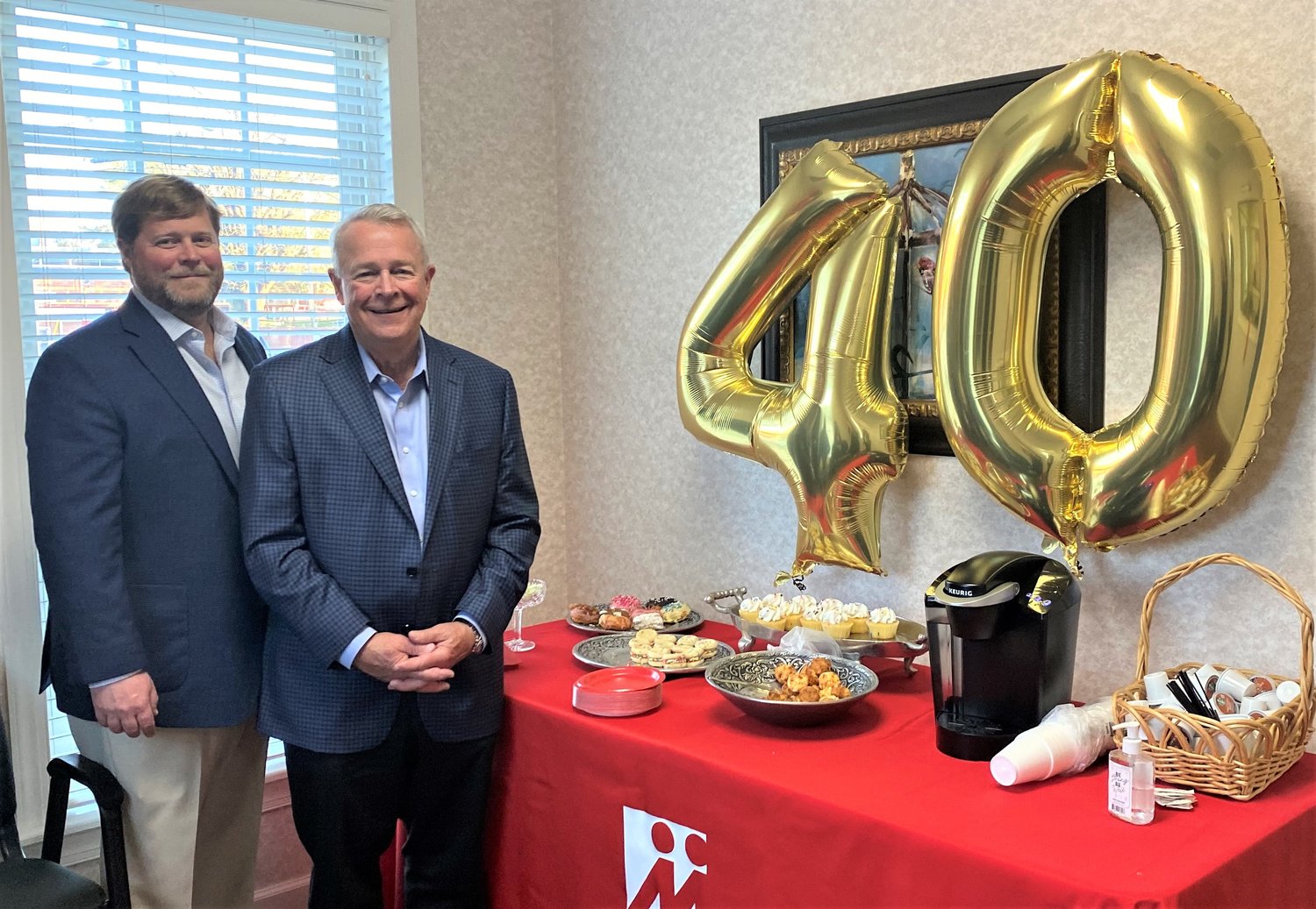 Heath Stone, left, director of operations, and Jerry F. Stone, president and CEO, mark the 40th anniversary of Mega Force Staffing.