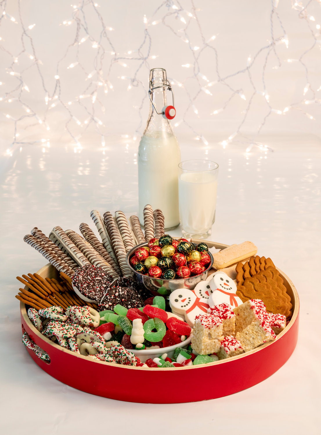 Because young palettes are not likely to go for cured meats and spicy cheeses, this Christmas-themed board served up peppermint sticks; Rice Krispie treats; marshmallow snowmen; ginger snaps; chocolate-swirled pretzel sticks; and ginger star cookies.