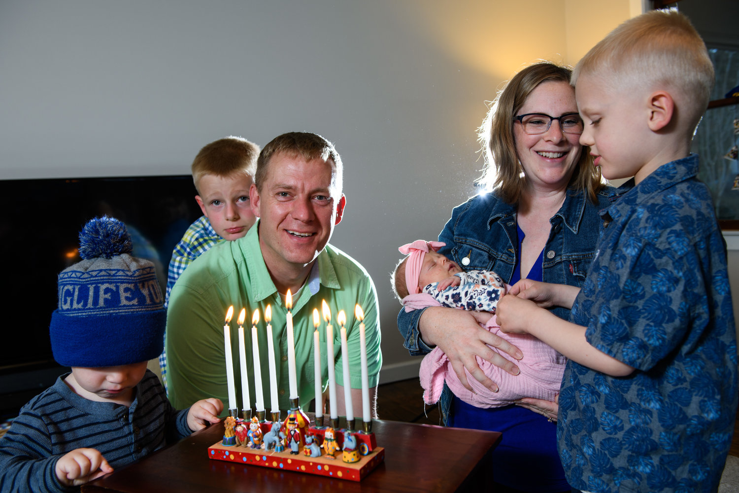Opposite, the Belifield family incorporates both Jewish and Christian traditions in their celebration of the holidays. Mom Rachael’s family observed some Jewish traditions when she was growing up. From left are Iliza, 2; Samuel, 7; dad Michael; mom Rachael with baby Naomi; and Malakai, 5.